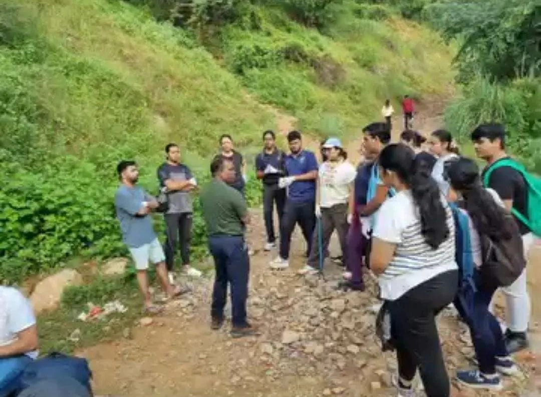 Volunteers gathered on a hillside trail