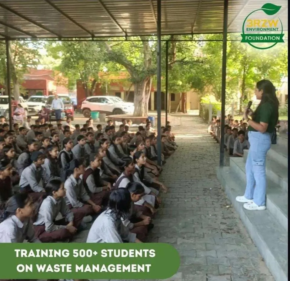 Speaker addressing rows of seated students outdoors